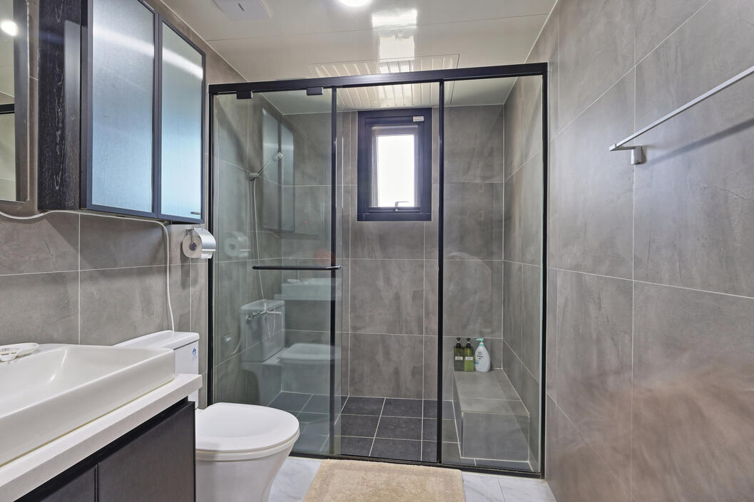 The bathroom is a large modern dry bath with a walk-in shower. The bathroom is a large modern dry bath with a walk-in shower.