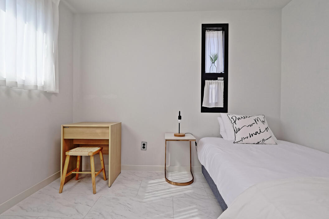 The second bedroom includes a Super-single bed, night stand with lamp, vanity and clothes rack. The second bedroom includes a Super-single bed, night stand with lamp, vanity and clothes rack.