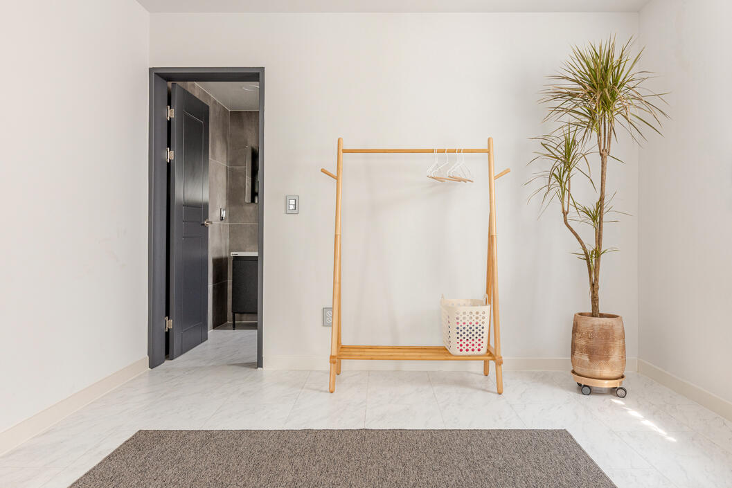 And a clothes rack for your convenience. The open door lead into the master bathroom And a clothes rack for your convenience. The open door lead into the master bathroom
